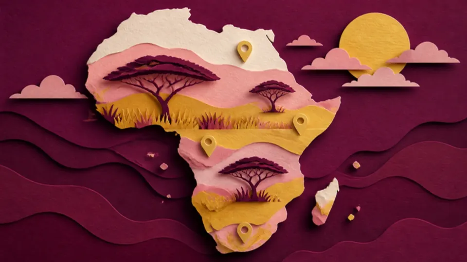 Paper-cut illustration of the African continent with acacia trees and a golden sun
