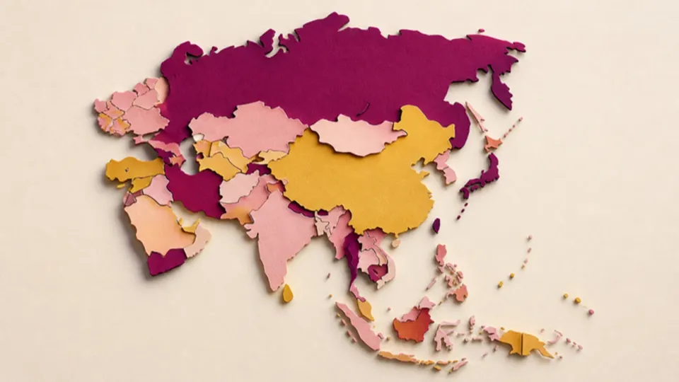 Paper-cut map of a large continent made from countries in plum, gold and pink