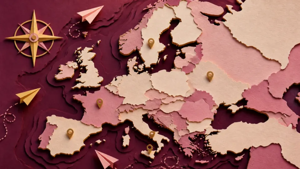 Paper-cut illustration of a map of Europe with gold map pins, a compass rose and paper airplanes